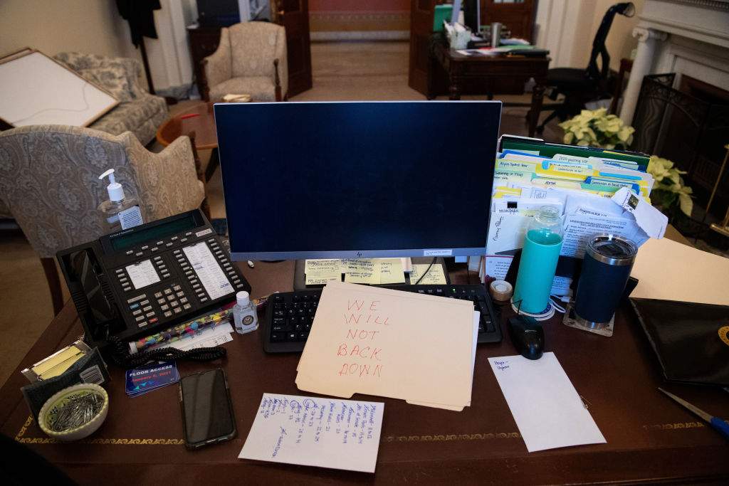 A supporter of U.S. President Donald Trump leaves a note in the office of U.S. Speaker of the House Nancy Pelosi as he protests inside the U.S. Capitol in Washington, D.C., on Jan. 6, 2021.