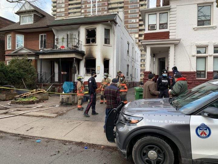 Emergency crews at the scene of a house fire in the area of Roncesvalles Avenue and Queen Street West on Sunday.