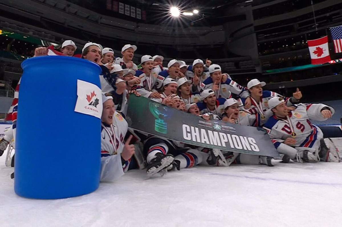 The gold medal-winning Team USA players pose with a barrel after winning the world junior championship on Jan. 5, 2021, in Edmonton.