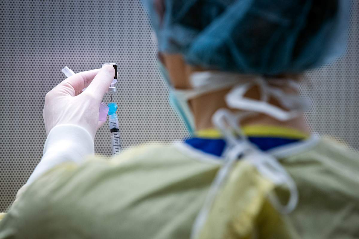Nurse looks at vaccine at Kingston General Hopsital on Jan. 12. 