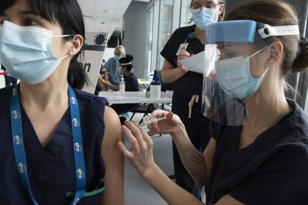 Health workers at the CHUM receiving their first dose of the COVID-19 vaccine