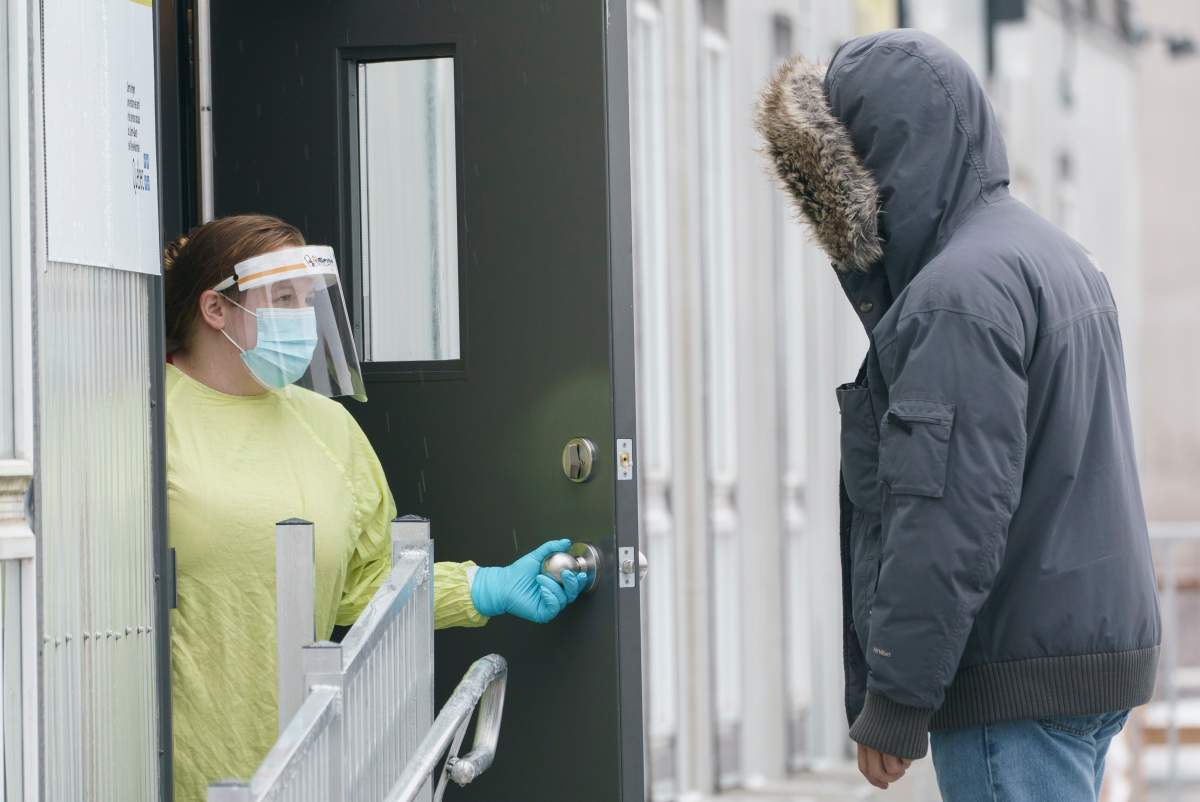 A health-care worker greets a patient at a COVID-19 test clinic in Montreal, on Thursday, January 14, 2021. 