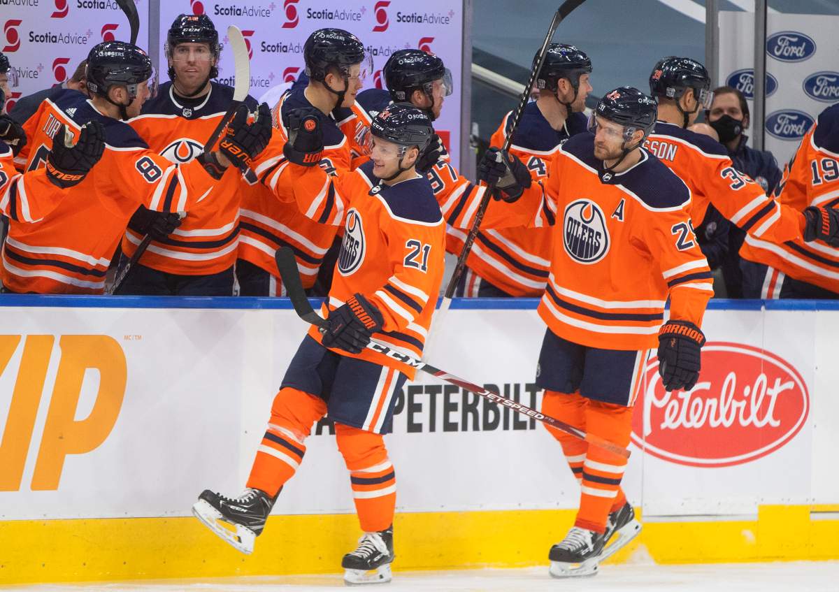 Edmonton Oilers' Dominik Kahun (21) and Leon Draisaitl (29) celebrate Kahun's goal against the Ottawa Senators with teammates on the bench during first period NHL action in Edmonton on Sunday, January 31, 2021. THE CANADIAN PRESS/Jason Franson.