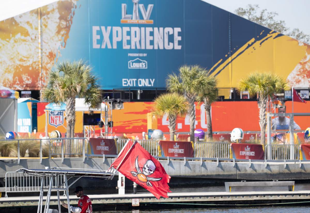 A Tampa Bay Buccaneers fan displays a flag on his boat as he passes the Super Bowl Experience compound, ahead of the NFL Super Bowl LV in Tampa, Florida.