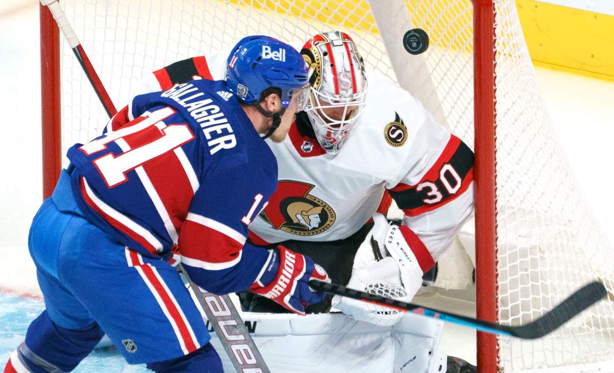 Ottawa Senators goaltender Matt Murray loses sight of the puck as Montreal Canadiens' Brendan Gallagher waits for the rebound during second period NHL hockey action in Montreal on Thursday, February 4, 2021. THE CANADIAN PRESS/Paul Chiasson.