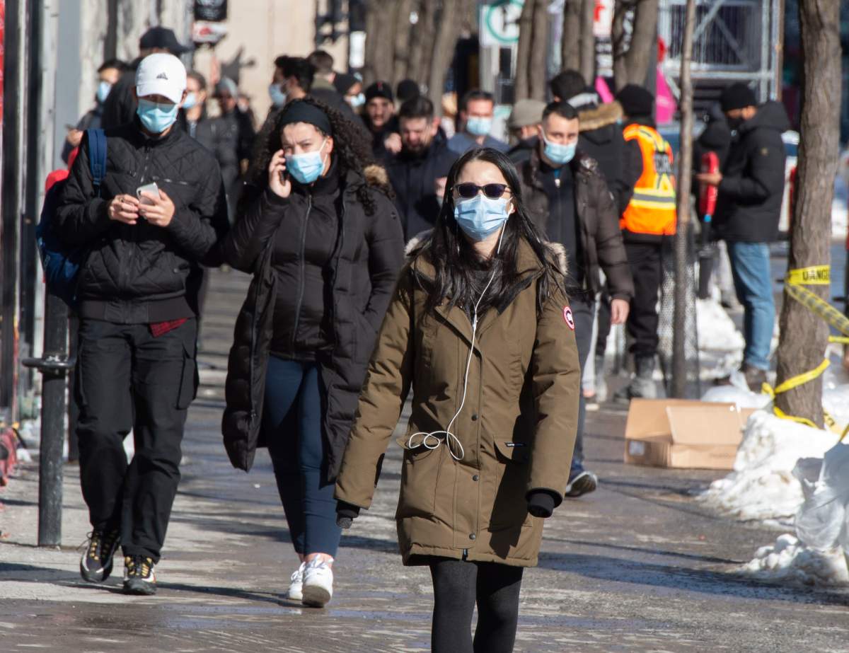 People make their way along St. Catherine street Wednesday, February 10, 2021  in Montreal.