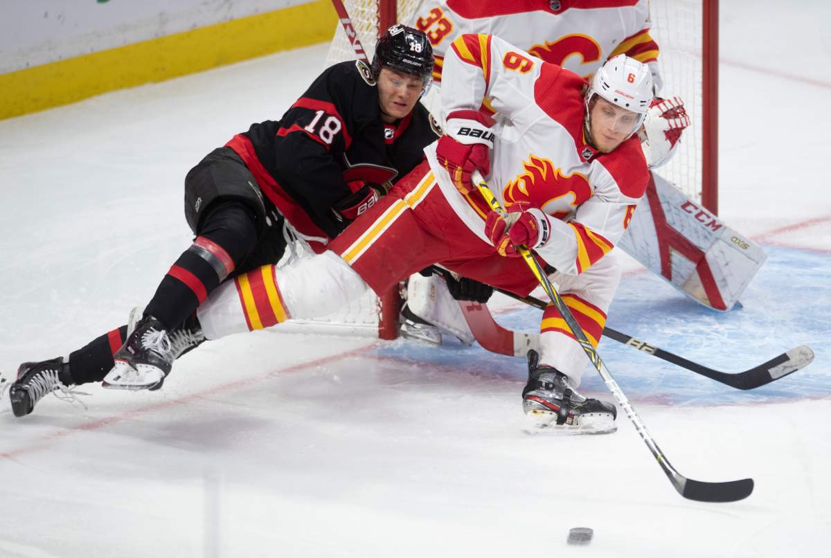 Calgary Flames defenceman Juuso Valimaki battles with Ottawa Senators left wing Tim Stutzle in front of the net during second period NHL action Thursday, February 25, 2021 in Ottawa. T.