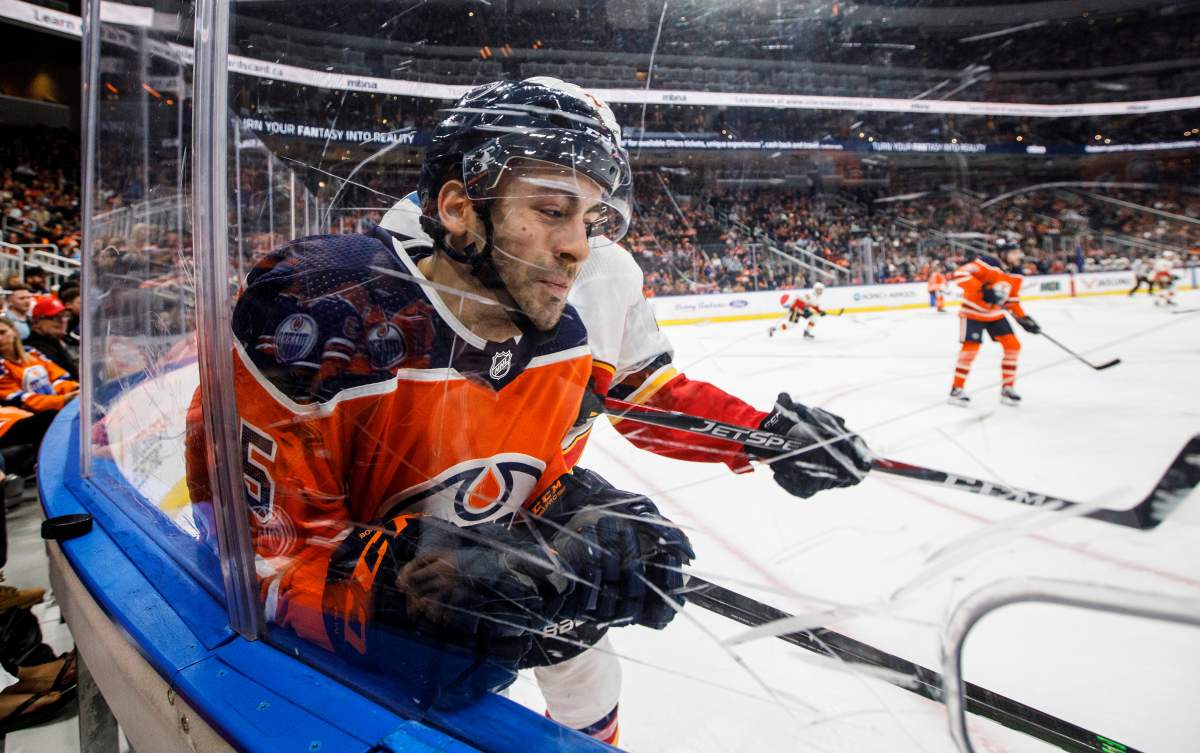 Calgary Flames' Dillon Dube (29) checks Edmonton Oilers' Evan Bouchard (75) during third period NHL pre-season action in Edmonton, Alta., on Friday September 20, 2019. THE CANADIAN PRESS/Jason Franson.