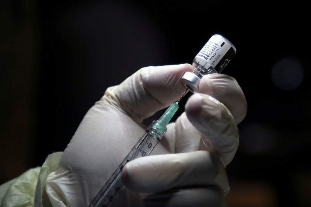 A health-care worker prepares to administer a Pfizer/BioNTEch coronavirus disease (COVID-19) vaccine at The Michener Institute, in Toronto on Dec. 14, 2020.