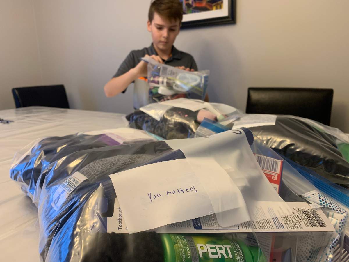 Loghan Wallace assembles care packages at his kitchen table.