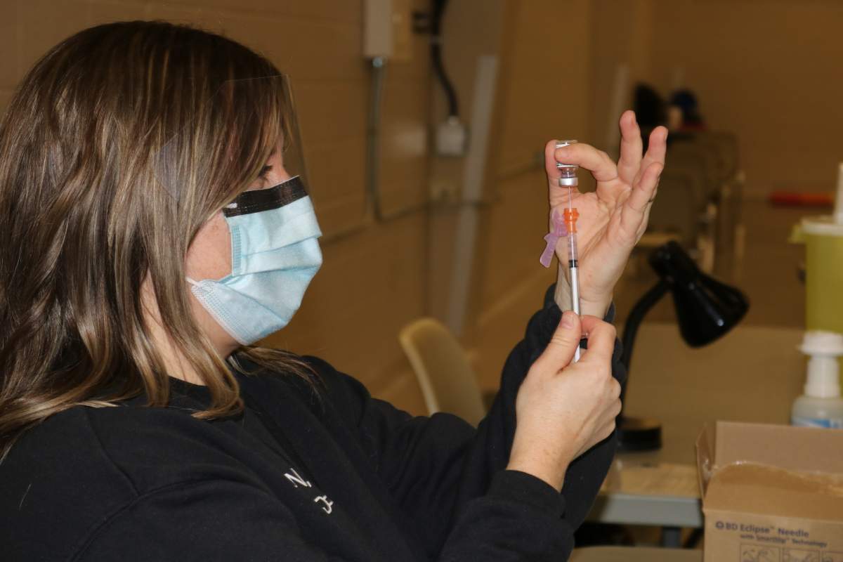 Public Health nurse Jill Seara extracting doses of the Pfizer-BioNTech vaccine at the Mount Brydges Vaccination Clinic on Feb. 18, 2021