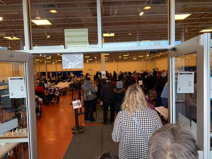 Long lines and crowds of people are seen inside a vaccination facility on Day 1 of Phase 1B of Alberta’s COVID-19 vaccine rollout on Feb. 25, 2021.