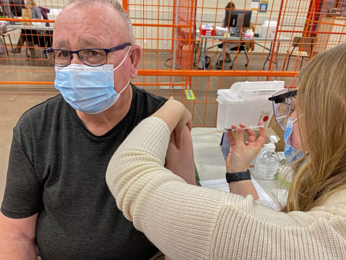 John Lindsay receives his first dose of the COVID-19 vaccine on Wednesday, Feb. 24, 2021, as part of the roll out to seniors 75 years and over in Alberta.