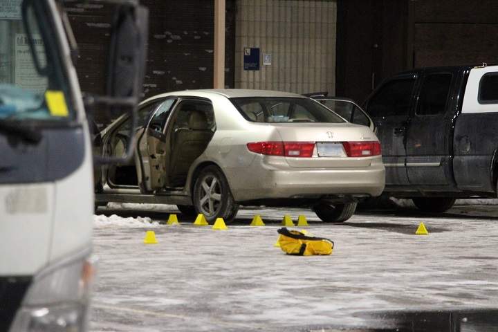 Police gathered evidence at a car at an Oak Street parking lot early Wednesday.