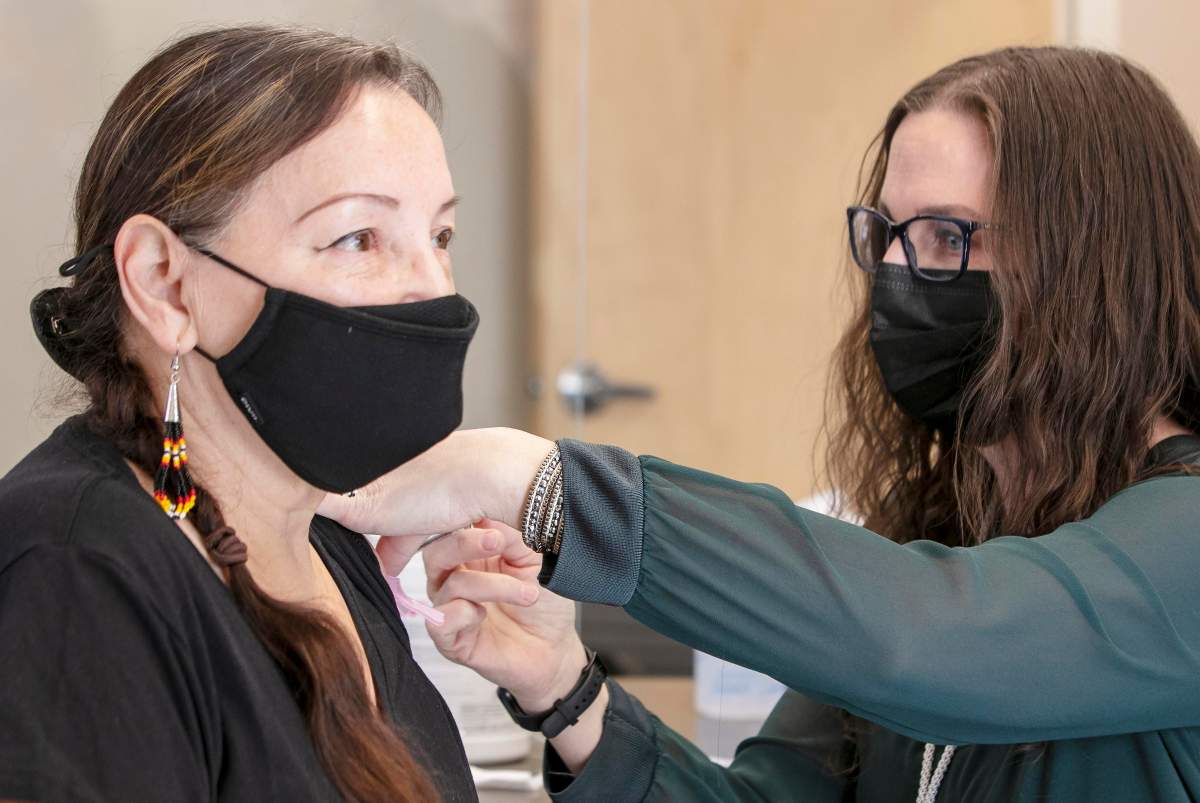 Nurse Suzette MacLeod administers the COVID-19 vaccine to elder Patsy Paul-Martin of Millbrook First Nation.