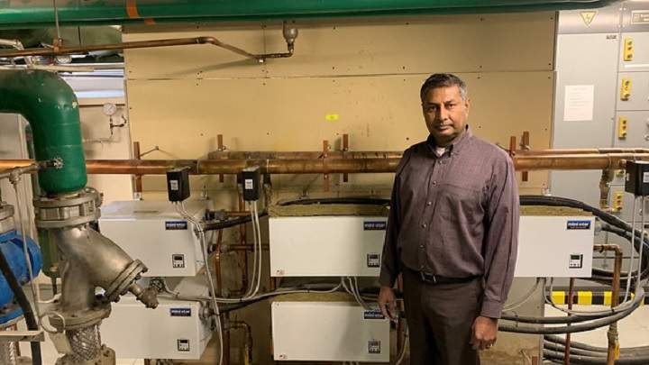 Infrastructure Minister Prasad Panda and the electric heating system in the Old Court of Appeal building in Calgary soon to be replaced by high efficiency boilers.