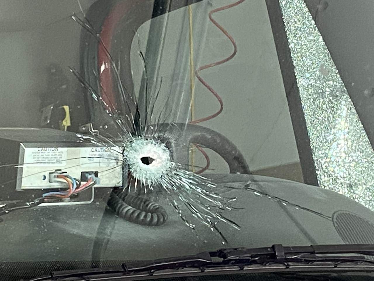 Image of a bullet hole in the windshield of an Onslow Belmont Brigade firetruck.