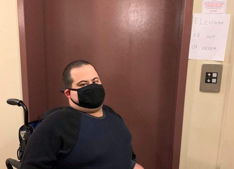 Adam Denney is seen inside his apartment building where the elevator has been out of order for more than two weeks. 