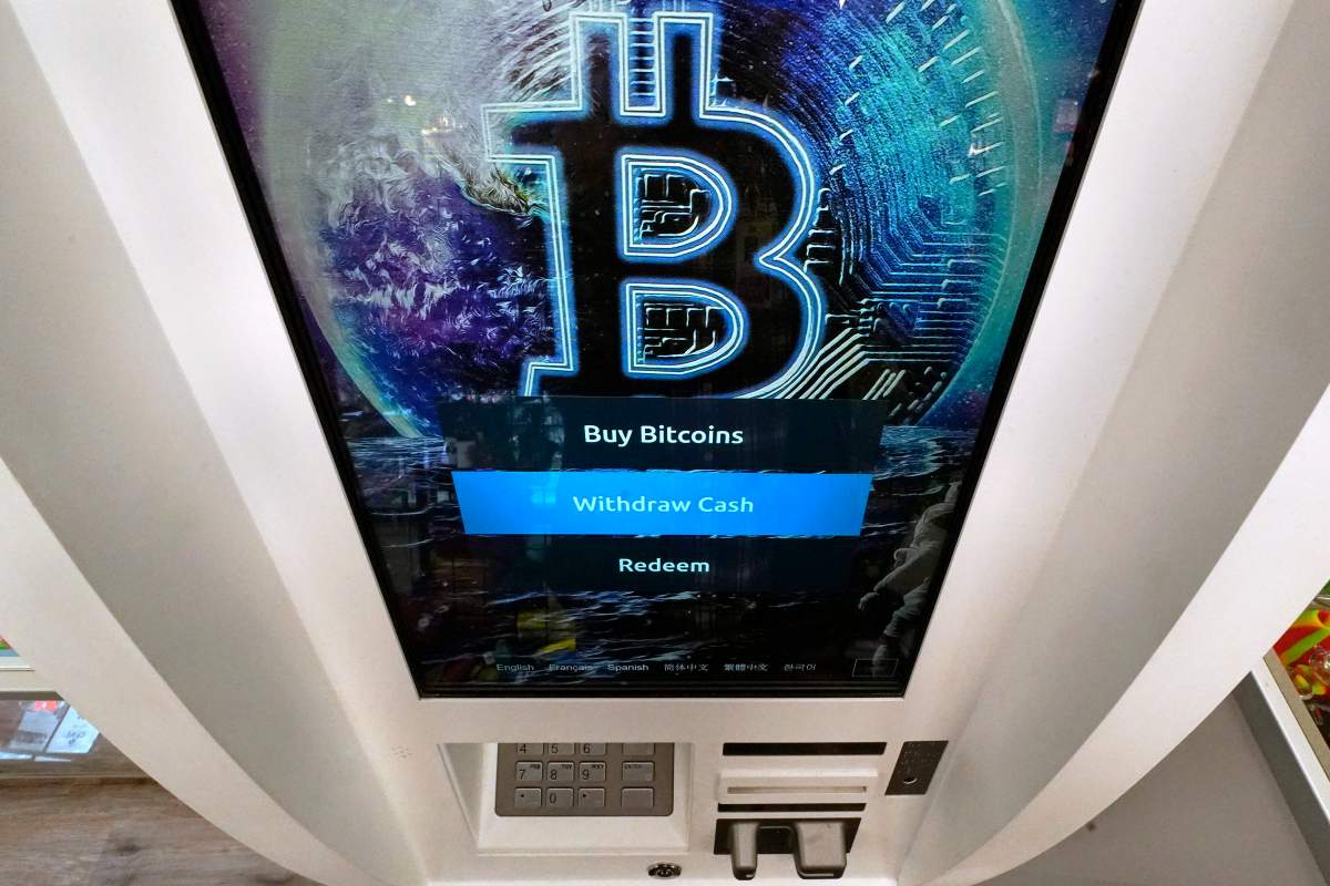 The Bitcoin logo appears on the display screen of a crypto currency ATM at the Smoker's Choice store, Tuesday, Feb. 9, 2021, in Salem, N.H.  