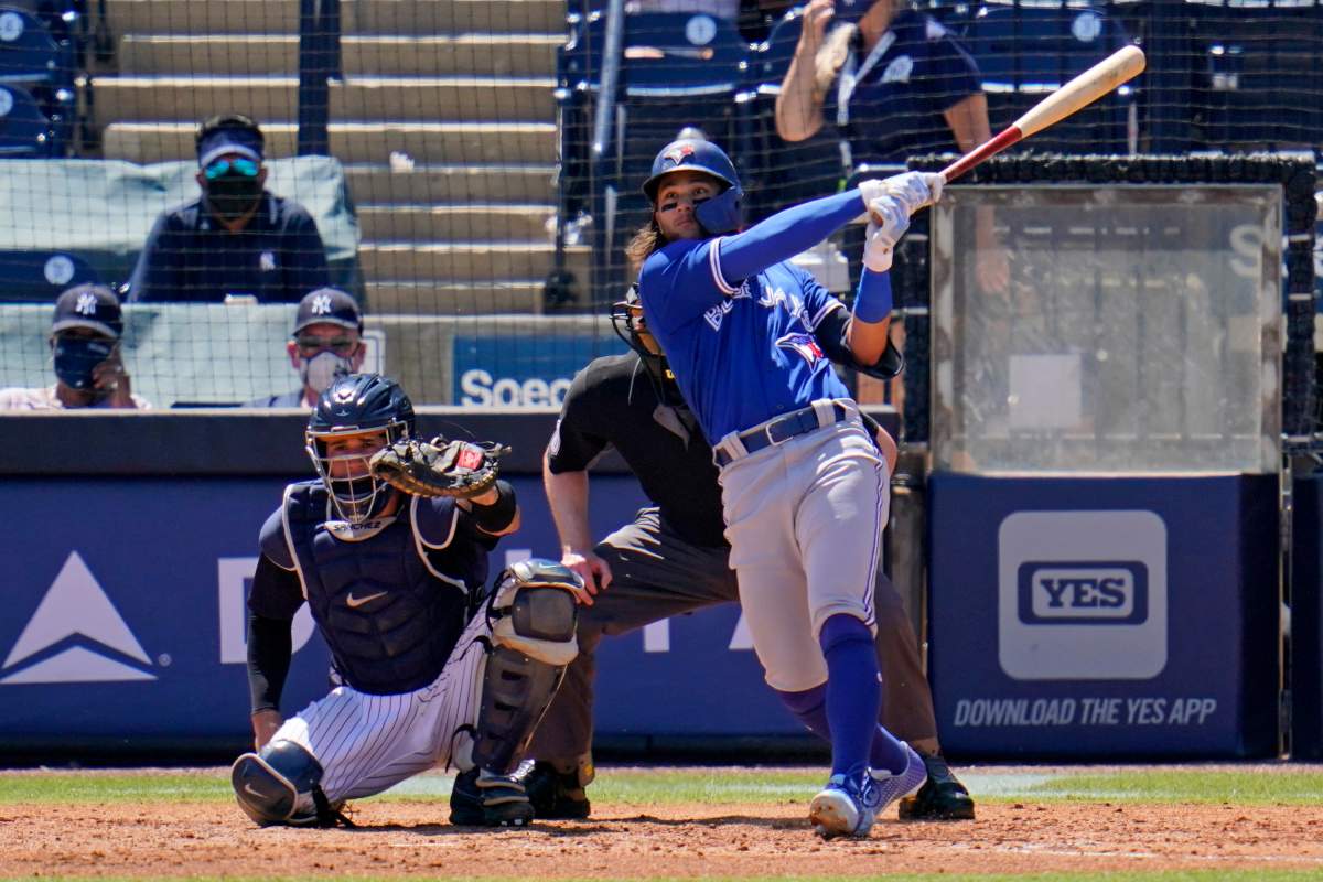 The Toronto Blue Jays' Bo Bichette, right, watches his solo home run off New York Yankees pitcher Luis Cessa during the fifth inning of a spring training exhibition baseball game in Tampa, Fla., Wednesday, March 24, 2021.