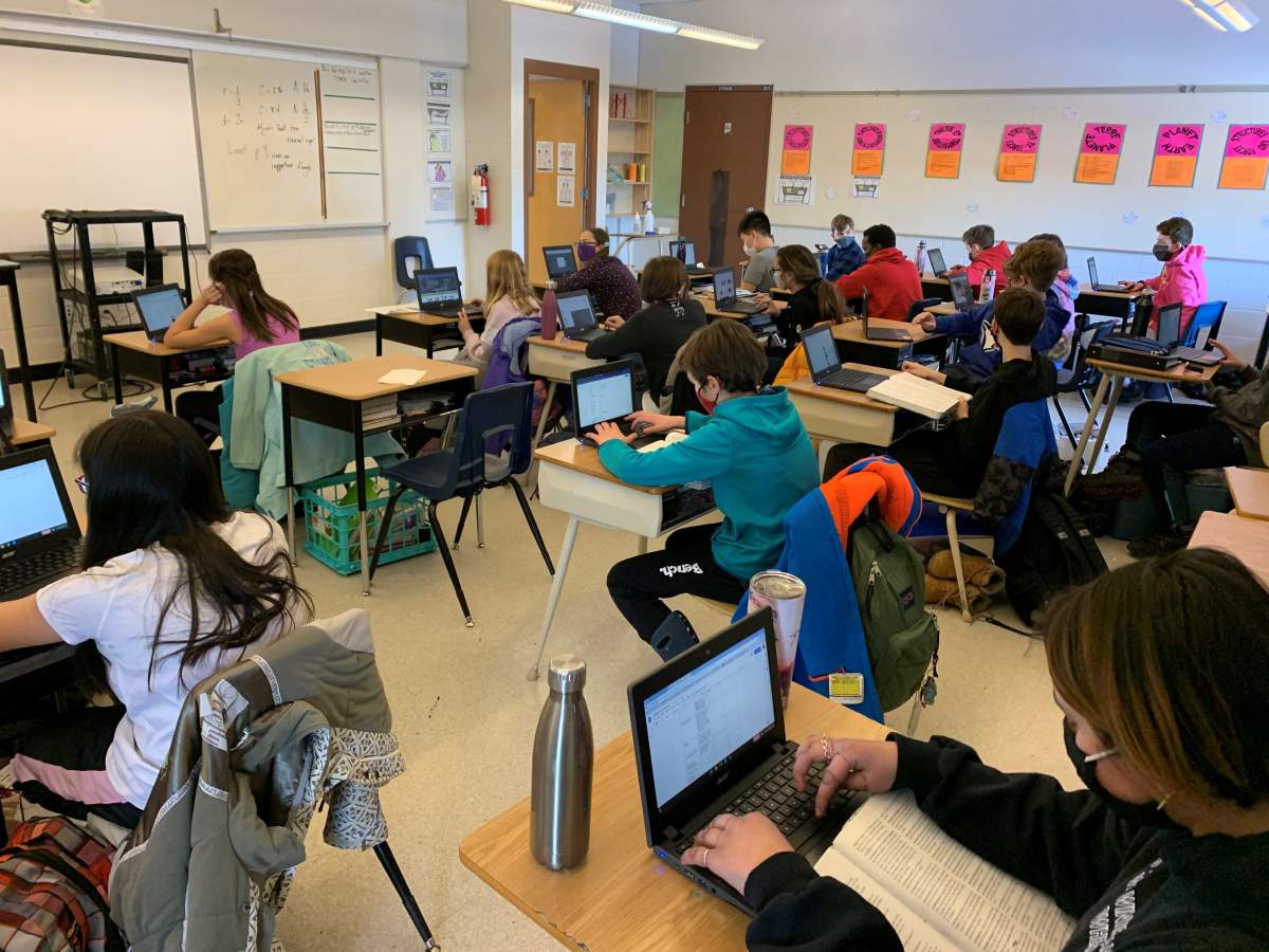 Kids use technology at St. Matthew School in Calgary in February 2021.