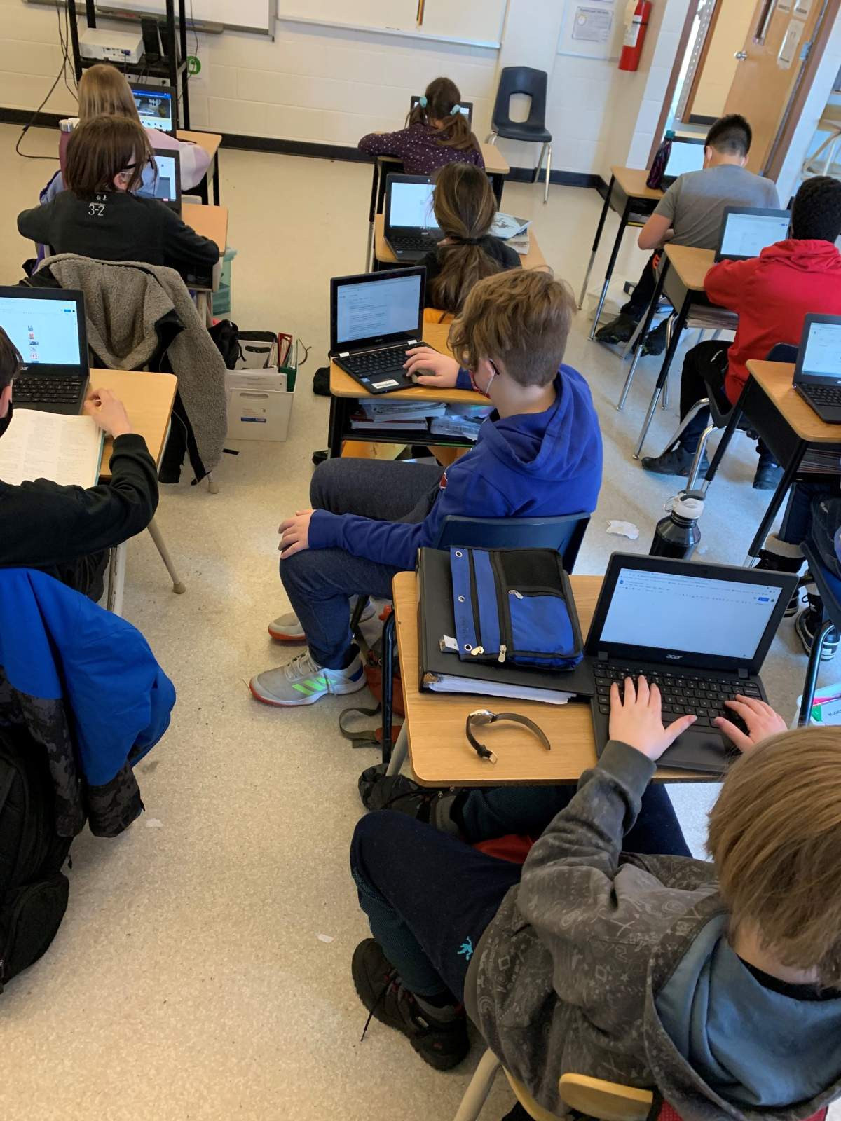 Kids use technology at St. Matthew School in Calgary in February 2021.