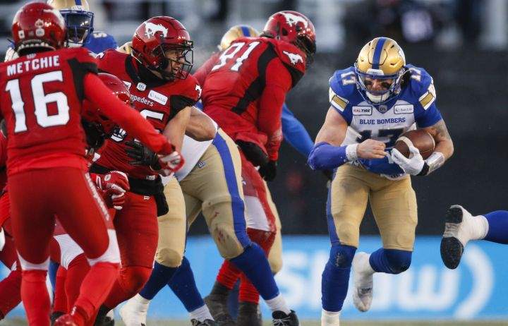 Winnipeg Blue Bombers quarterback Chris Streveler, right, runs the ball during CFL West Semifinal football action against the Calgary Stampeders, in Calgary, Sunday, Nov. 10, 2019. 