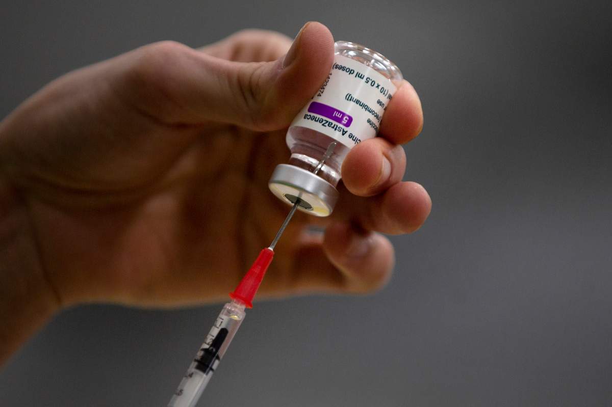 A pharmacist prepares a syringe from a vial of the AstraZeneca coronavirus vaccine during preparations at the Vaccine Village in Antwerp, Belgium, on Friday, Feb. 19, 2021. 