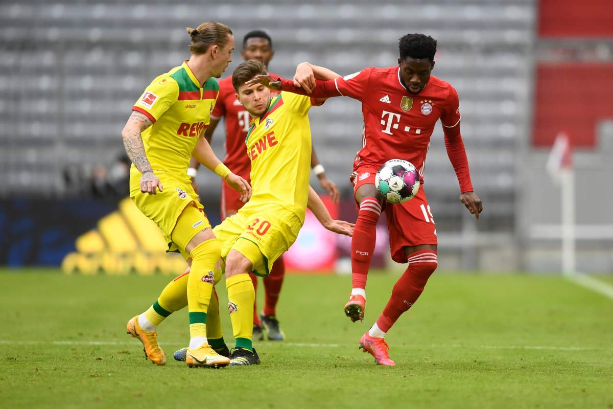 Cologne’s Marius Wolf, left, Elvis Rexhbecaj, centre, and Bayern’s Alphonso Davies challenge for the ball during a German Bundesliga soccer match between Bayern Munich and 1.FC Cologne in Munich, Germany, Saturday, Feb. 27, 2021. (AP Photo/Andreas Schaad)