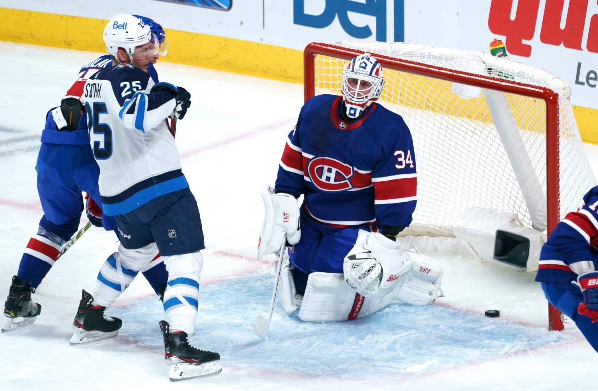 Montreal Canadiens goaltender Jake Allen reacts to a goal by the Winnipeg Jets' Paul Stastny, left, during first period NHL hockey action in Montreal on Thursday, March 4, 2021.