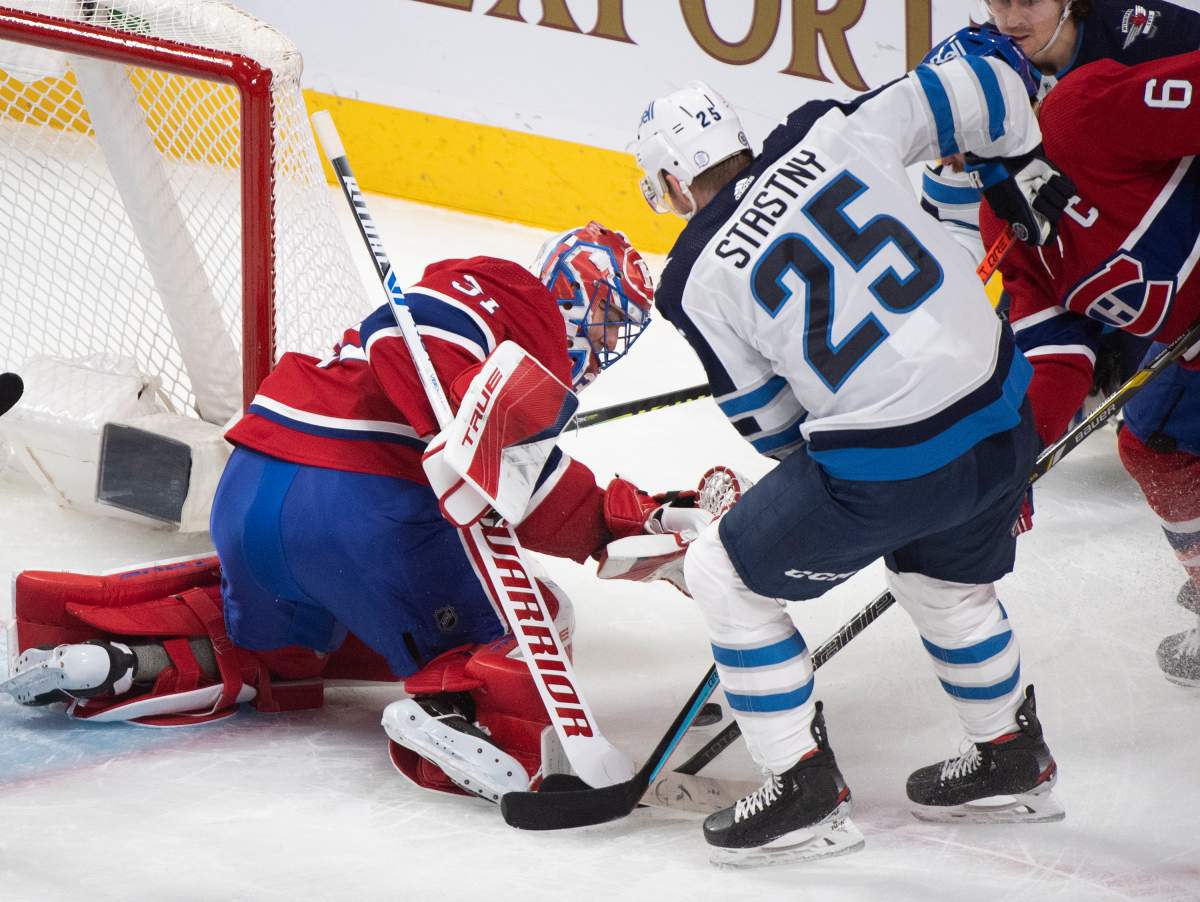 Montreal Canadiens goaltender Carey Price stops Winnipeg Jets’ Paul Stastny (25) during first period NHL hockey action in Montreal, Saturday, March 6, 2021.