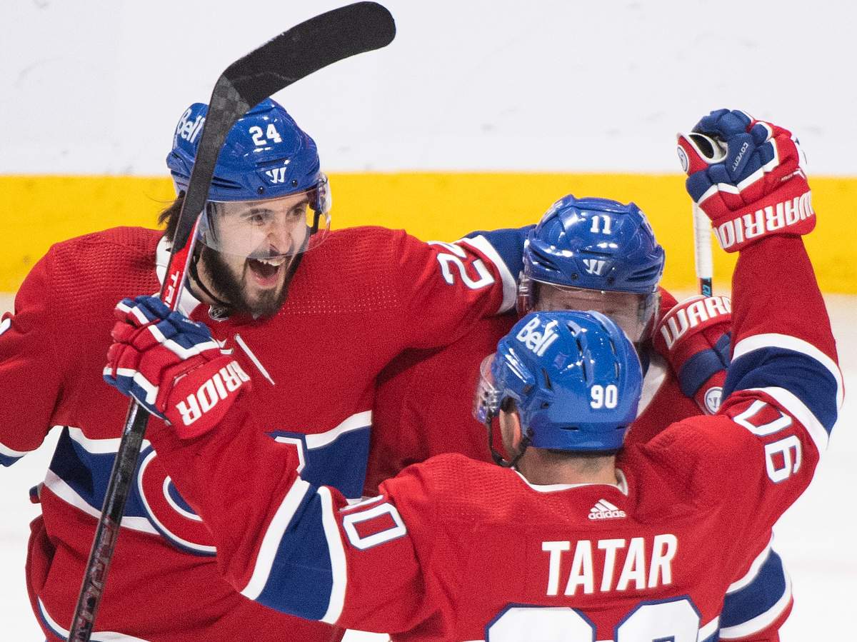 Montreal Canadiens’ Brendan Gallagher (11) celebrates with teammates Phillip Danault (24) and Tomas Tatar (90) after scoring against the Winnipeg Jets during second period NHL hockey action in Montreal, Saturday, March 6, 2021. 