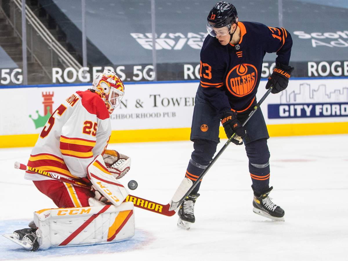 Edmonton Oilers' Jesse Puljujarvi (13) is stopped by Calgary Flames goalie Jacob Markstrom (25) during second period NHL action in Edmonton on Saturday, March 6, 2021.THE CANADIAN PRESS/Jason Franson.