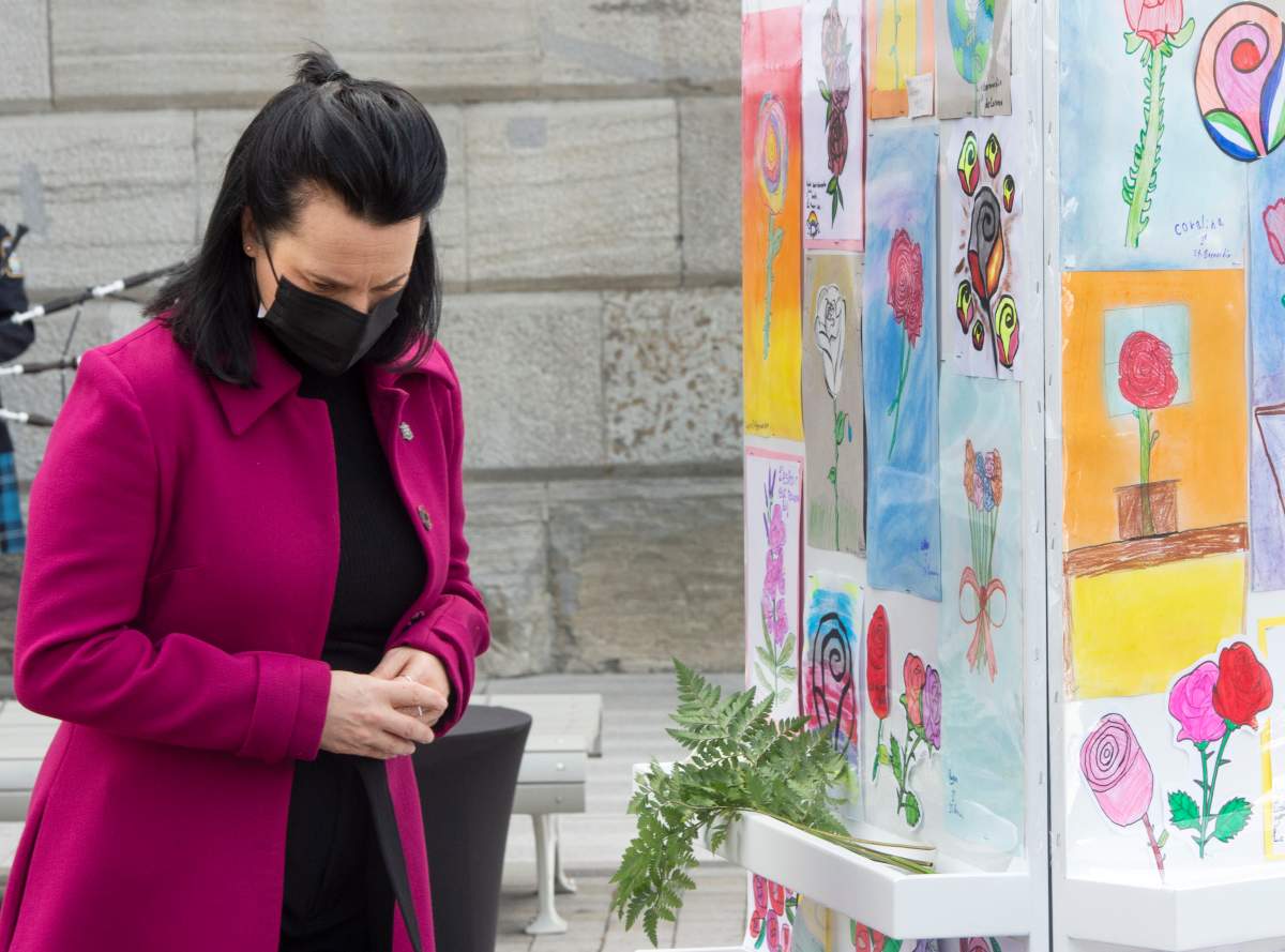 Montreal Mayor Valerie Plante pauses after placing a flower at a memorial during a ceremony to remember those who were lost during the pandemic, in Montreal, Thursday, March 11, 2021.