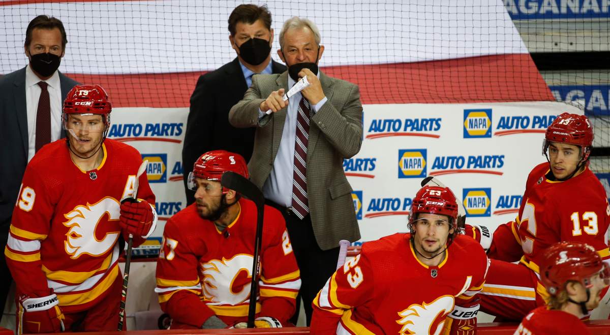 Calgary Flames head coach Darryl Sutter, centre, directs his team during first period NHL hockey action against the Winnipeg Jets in Calgary, Monday, March 29, 2021.