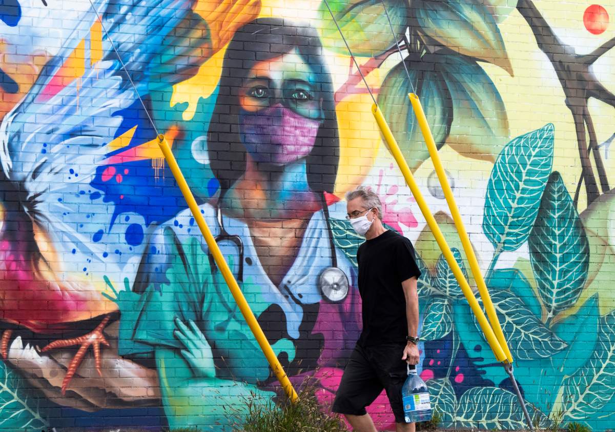 There are now 36 people in hospital with COVID-19 in Ottawa, 12 of whom are in the intensive care unit. Mural by artist Dom Laporte.