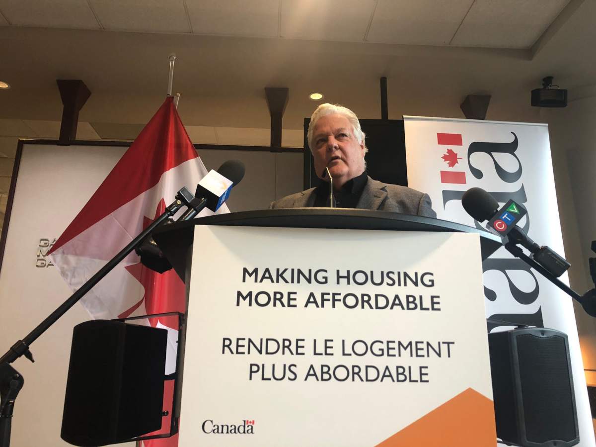 Dale Hicks, co-founder of Rising Tide, speaks at a press conference at Moncton City Hall on Friday. He expects about 160 affordable units to be created over the next three years
