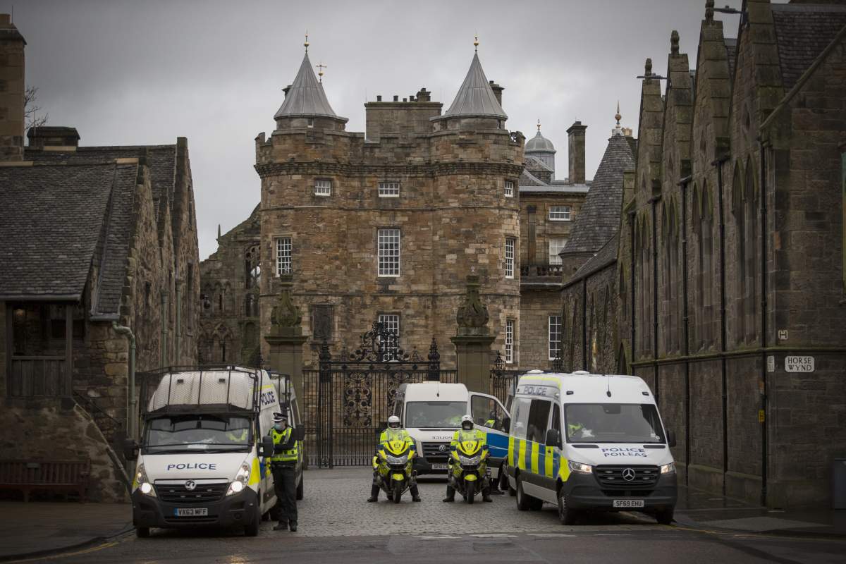 Police during a Scotland Against Lockdown protest outside the Place of Holyrood house opposite the Scottish Parliament in Edinburgh.