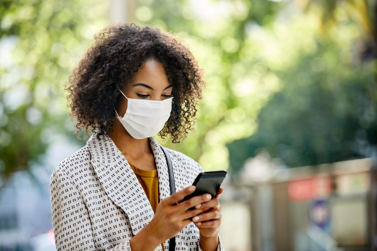 A woman walking with her cell phone. 