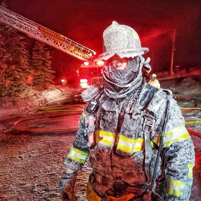 A Kennebecasis Valley firefighter is seen with frozen gear at a fire on Tuesday. 