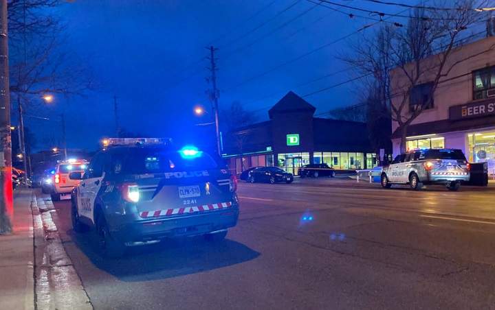 Officers respond to a bank on Lake Shore Boulevard West Friday evening.