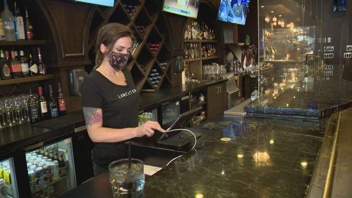 Tracy Lee Herauf types in a takeout order at The Lancaster Taphouse downtown location.