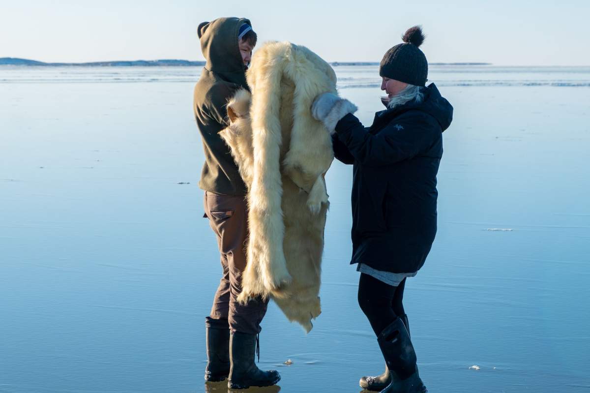 Tuktoyuktuk artist Maureen Gruben working with a polar bear hide.