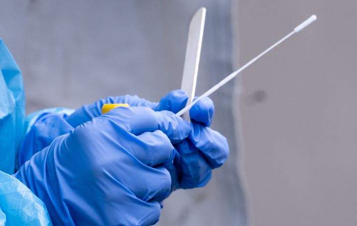 A file photo of a nurse getting a swab ready at a temporary COVID-19 test clinic.