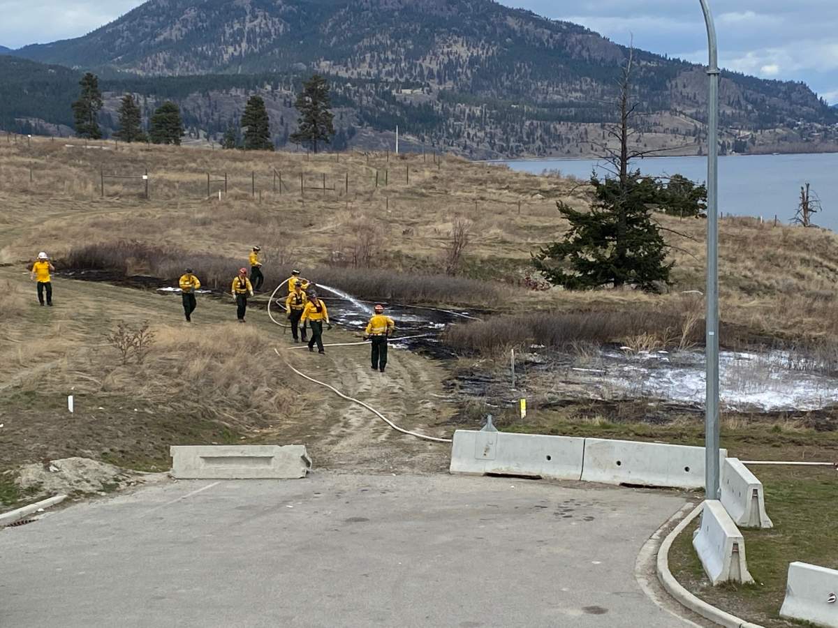 West Kelowna Fire Rescue crews mop up a grassfire near the W.R. Bennett Bridge on Saturday afternoon.