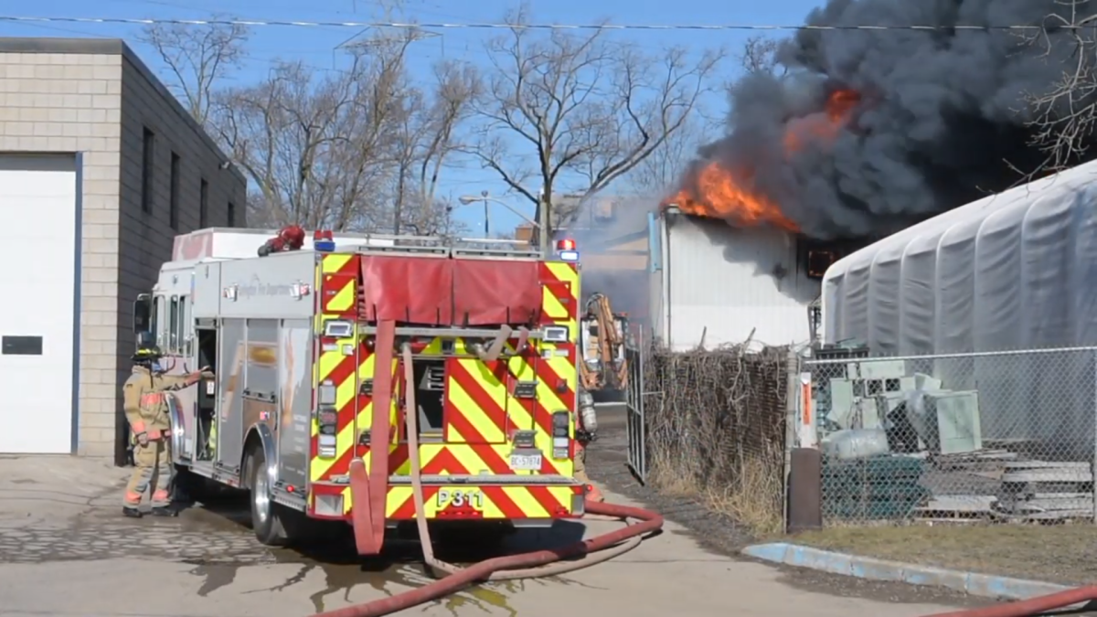 Firefighters battle a large  blaze at a building on Pettit Road in Burlington on March 12, 2021.
