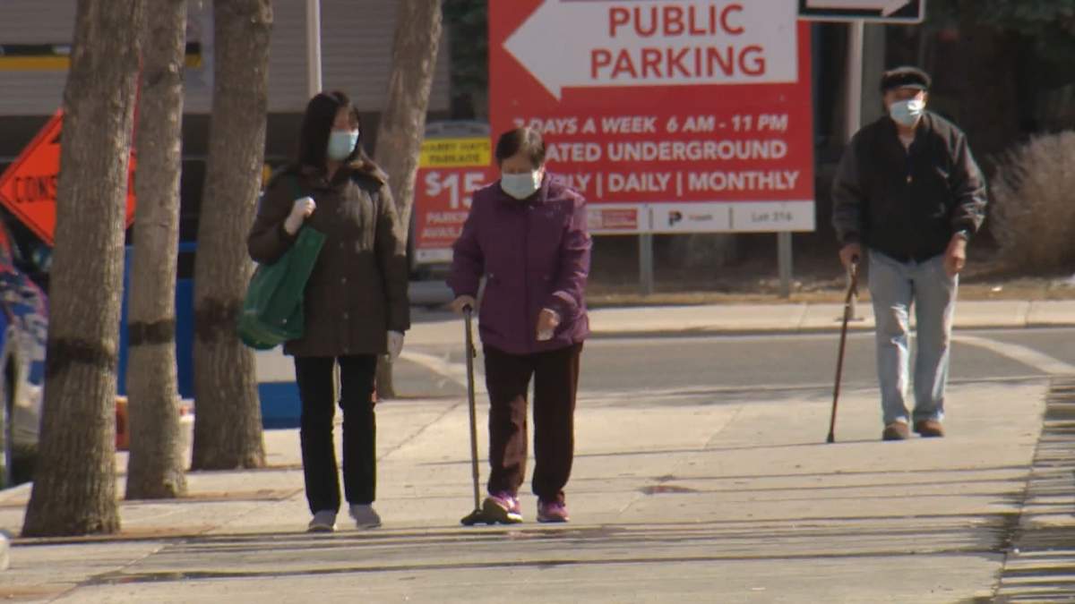 Members of the Asian community walk along the streets of Chinatown in Calgary.