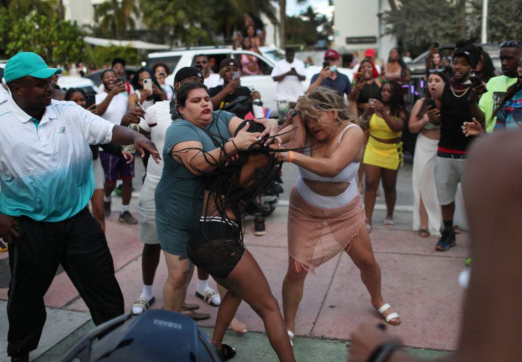 Women fight on the street near Ocean Drive on March 19, 2021, in Miami Beach, Fla.
