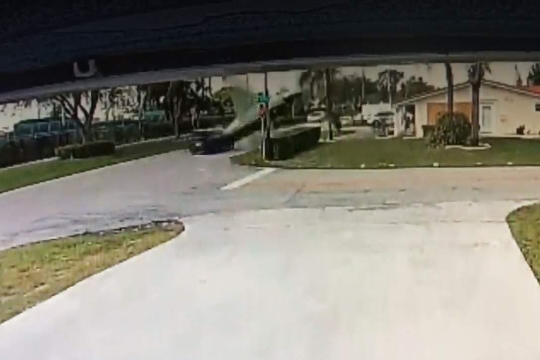 An SUV and a small aircraft are shown just before they collided outside an airport in Pembroke Pines, Fla., in this image from a doorbell camera on March 15, 2021.