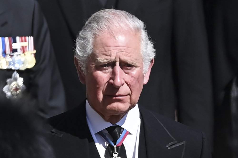 Britain’s Prince Charles sheds a tear as he follows the coffin as it makes it’s way past the Round Tower during the funeral of Britain’s Prince Philip inside Windsor Castle in Windsor, England Saturday April 17, 2021.